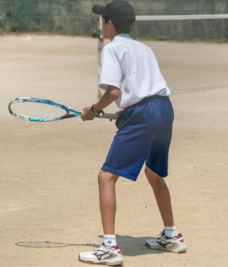 child playing tennis 