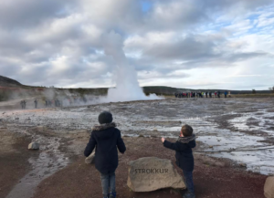 kids at a geysir in Iceland 