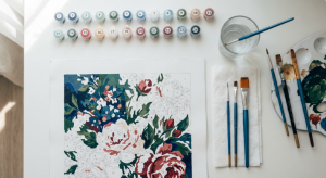 Organized paint by numbers supplies and workspace setup showing paints, brushes, and canvas
